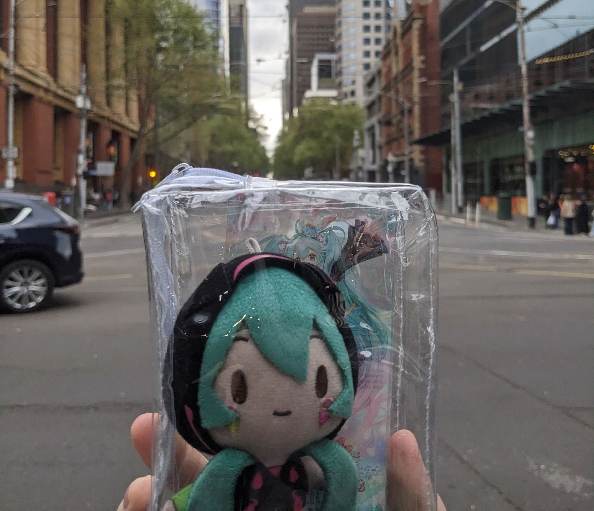shot of lovely miku plushie charm who came with me on backdrop of the street from southern cross station shot of lovely miku plushie charm who came with me on backdrop of the street from southern cross station