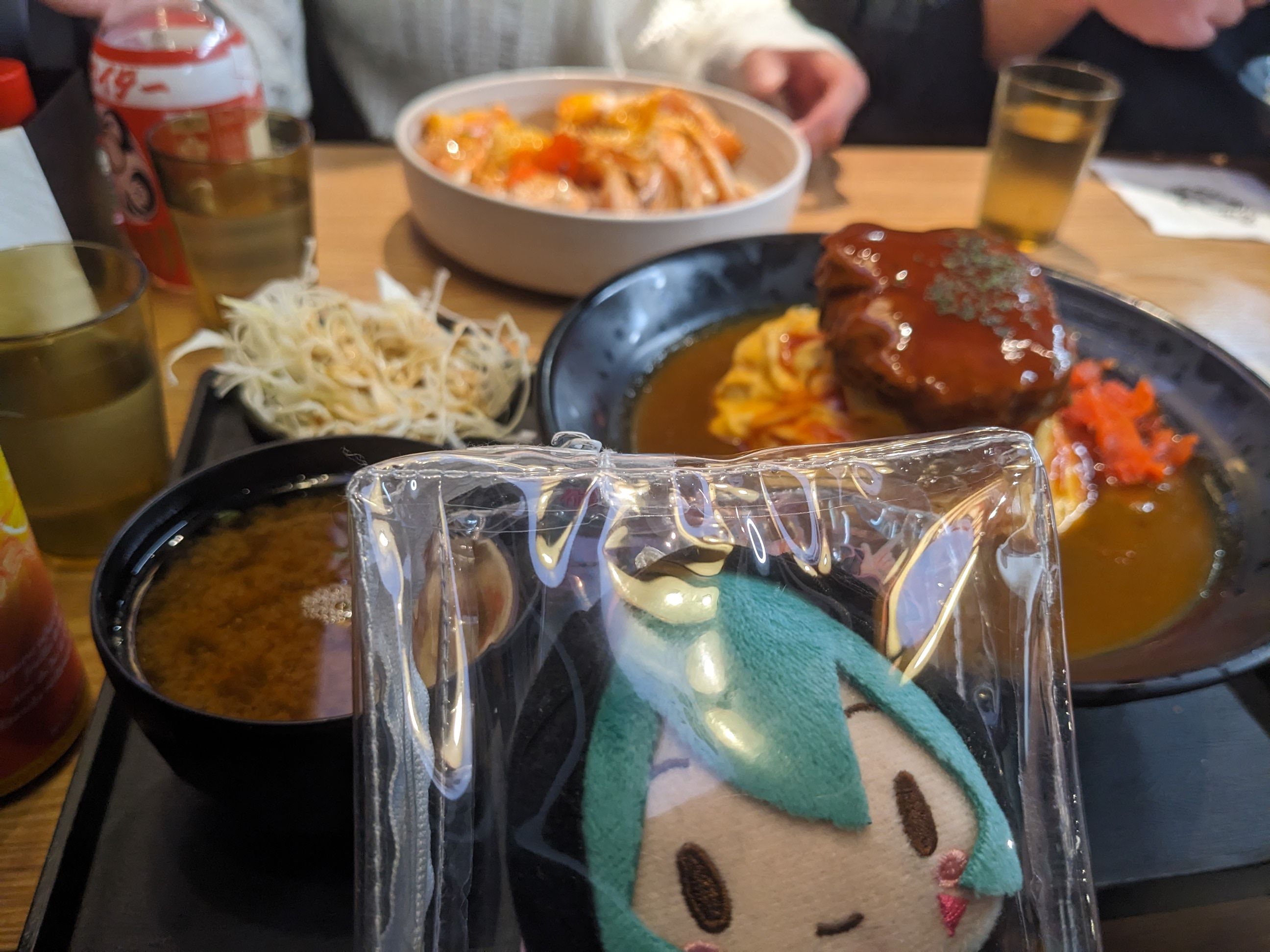 miku evil and scheming in front of hamburg steak curry rice meal miku evil and scheming in front of hamburg steak curry rice meal