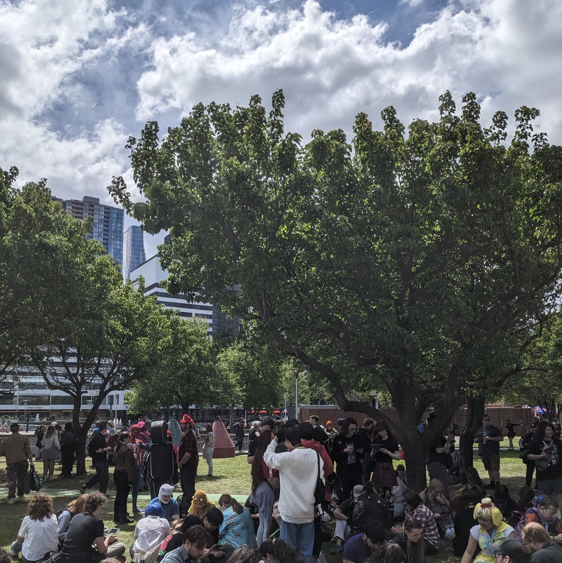 crowd of people on their 3ds' in a park crowd of people on their 3ds' in a park