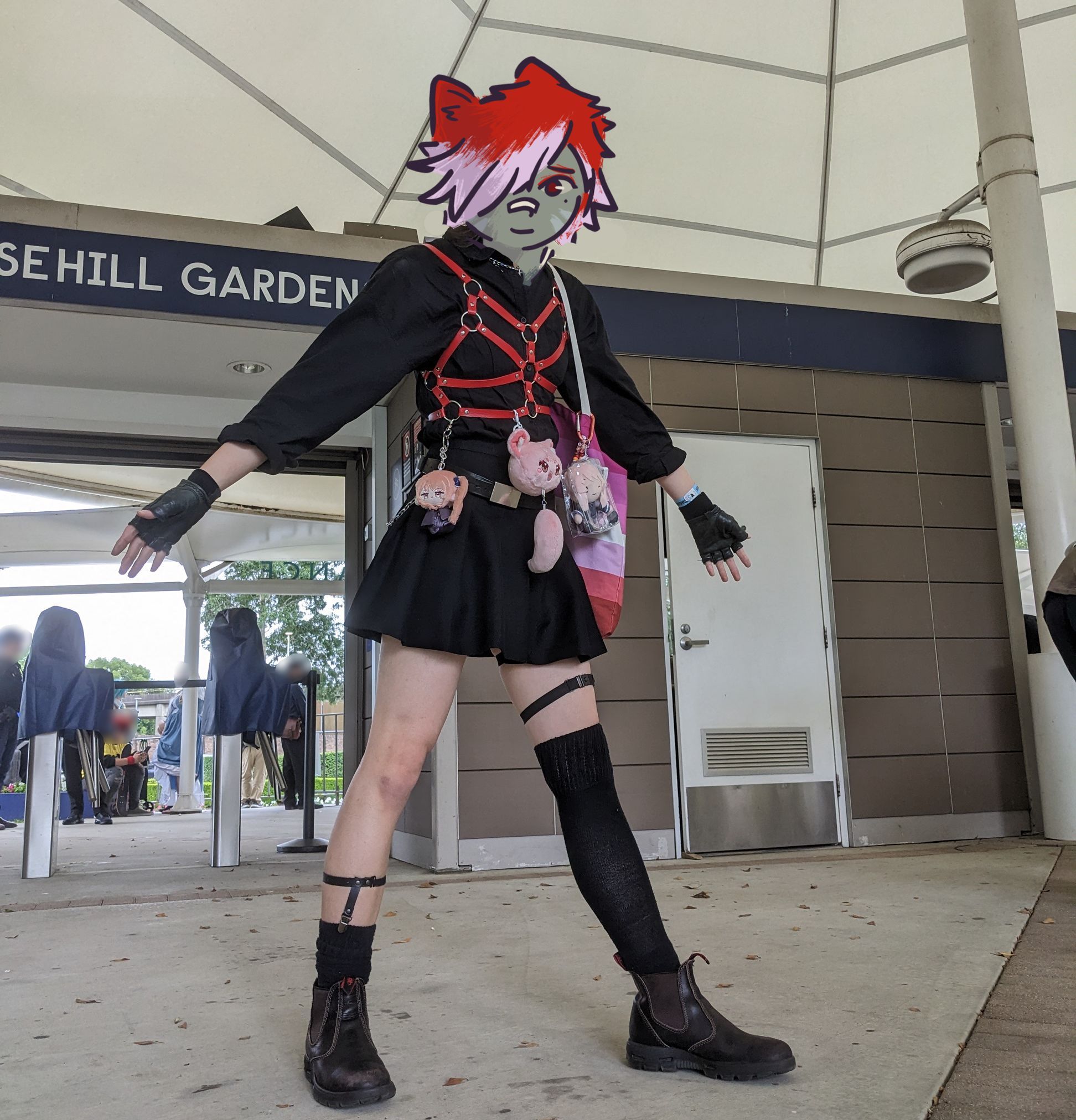 me in a black shirt and skirt, red harness and uneven thigh highs with several mizuki project sekai nuis hanging off my harness