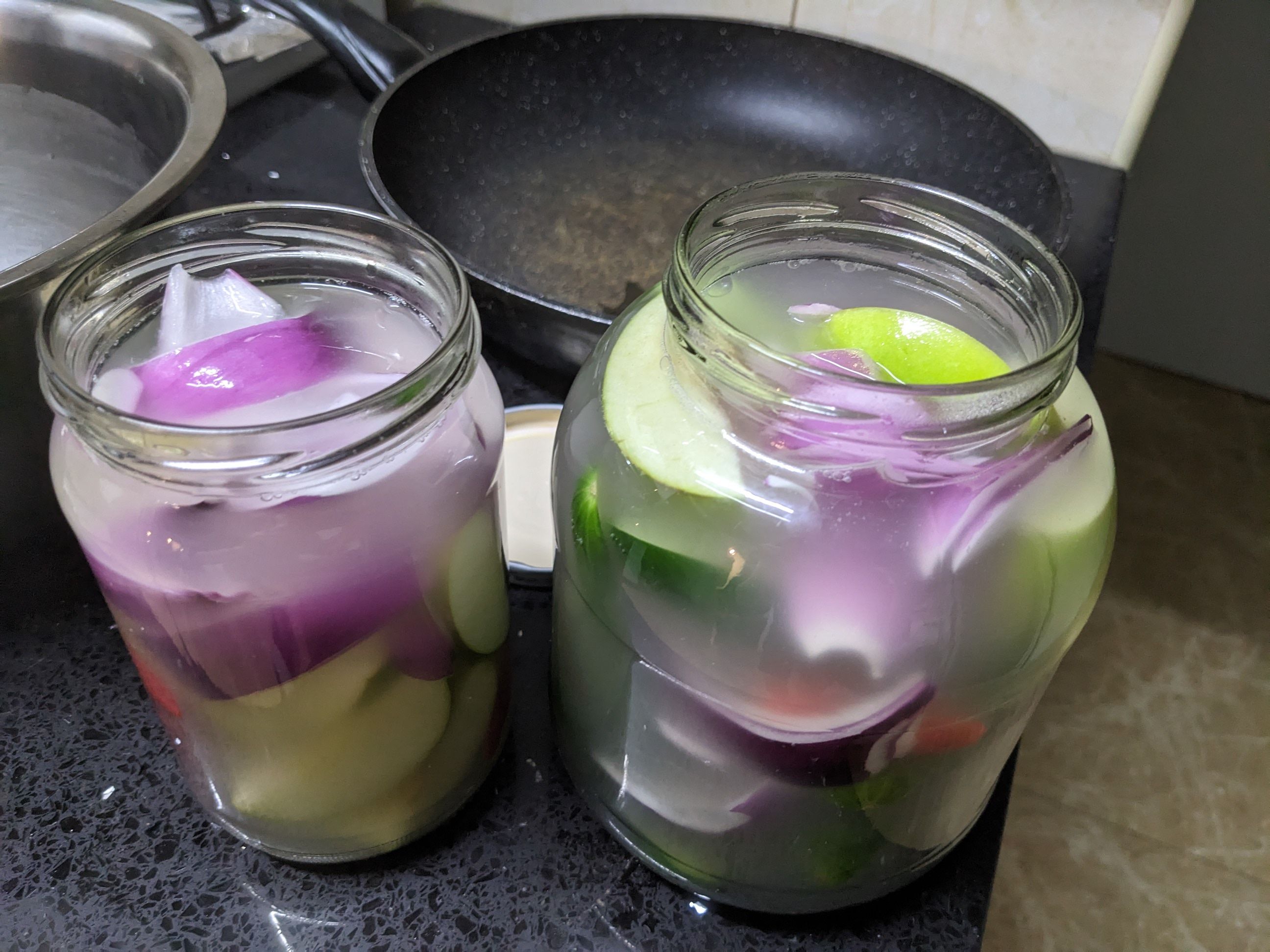 2 jars of pickles with onion, cucumber, chilli and green apple